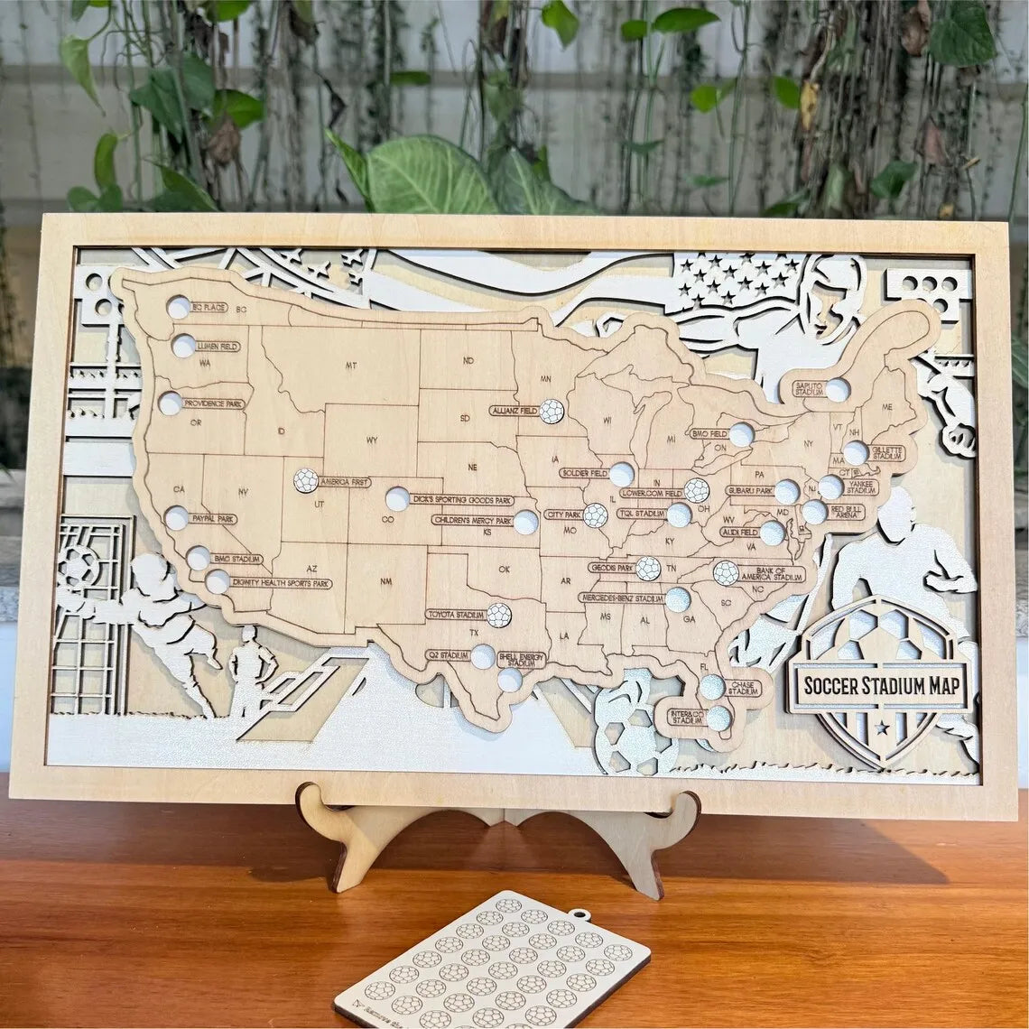 Wooden map of the United States with soccer stadiums on a stand