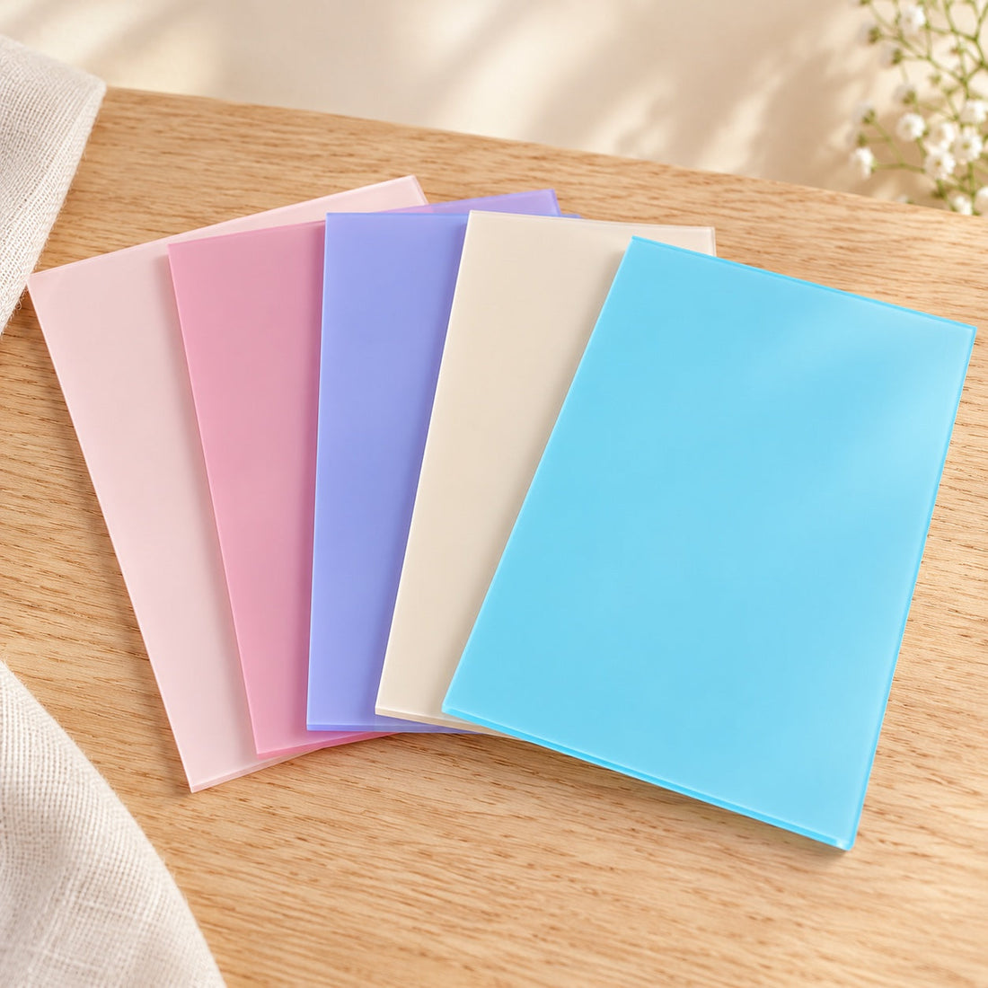 Acrylic sheets in peach, pink, lilac, beige and sky blue on pale oak