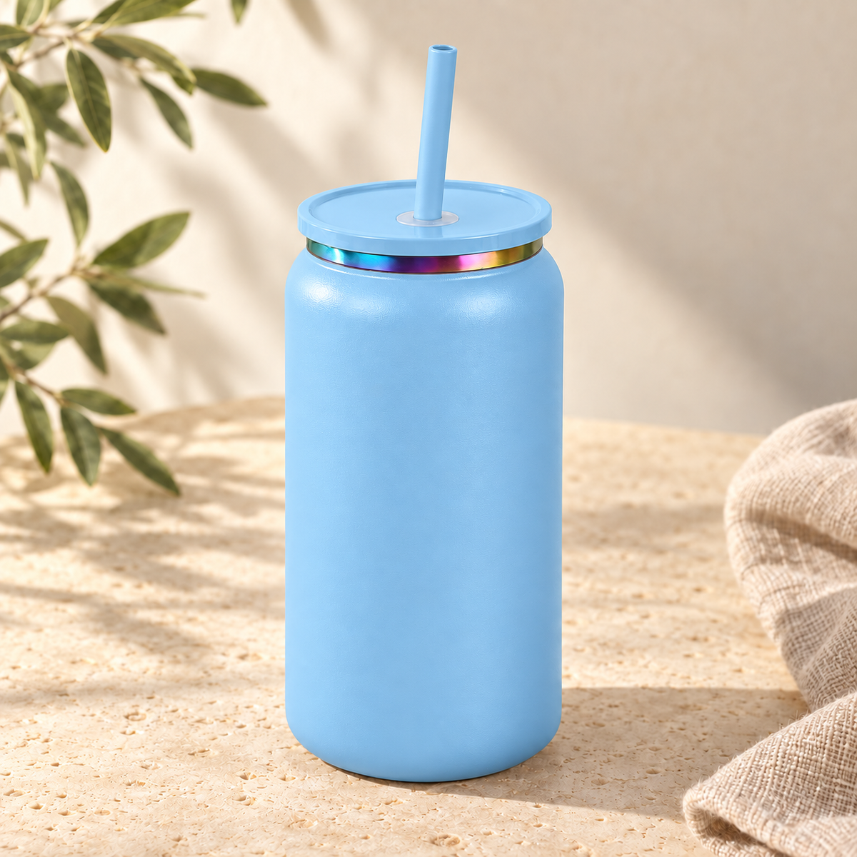Sky blue 16oz can tumbler with straw on warm cream stone