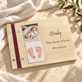 Baby shower guest book with photo and footprint cover on warm stone