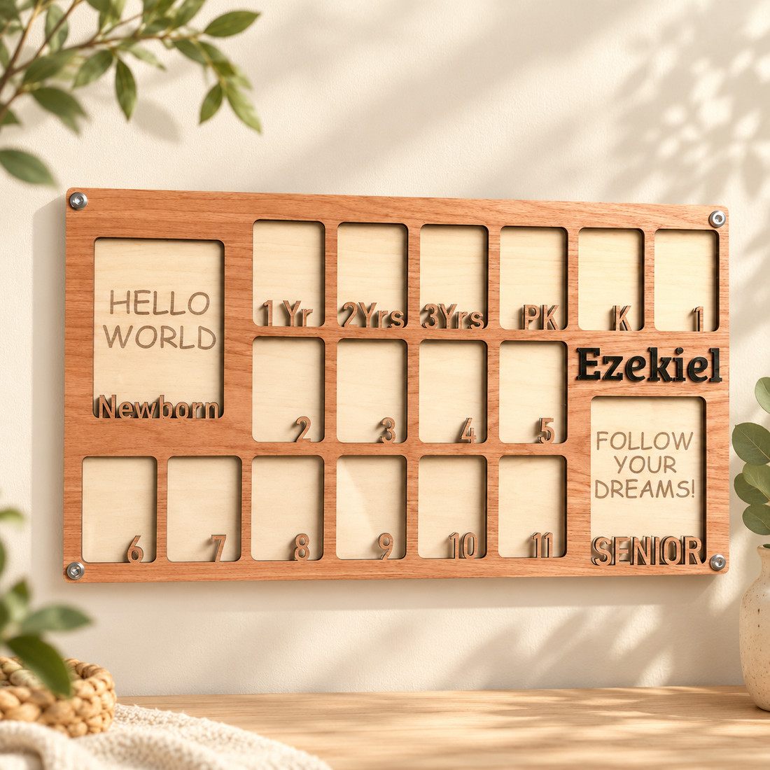 Natural wood newborn-to-graduation photo frame in a warm cream and sage setting
