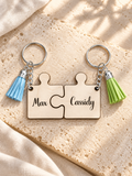 Wooden puzzle keychains engraved Max and Cassidy, joined on warm stone