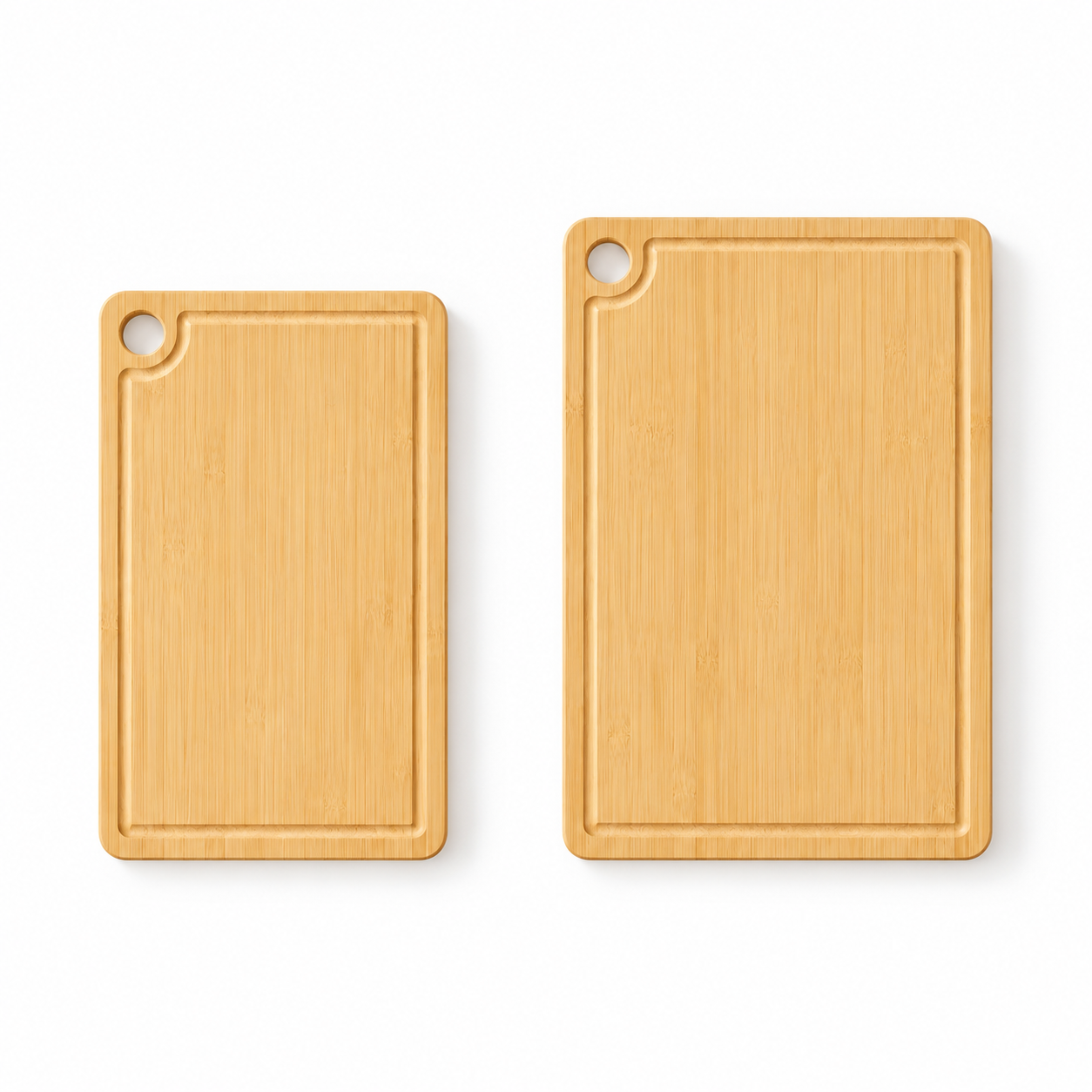 Two blank bamboo cutting boards on a white background, showing the medium and large sizes