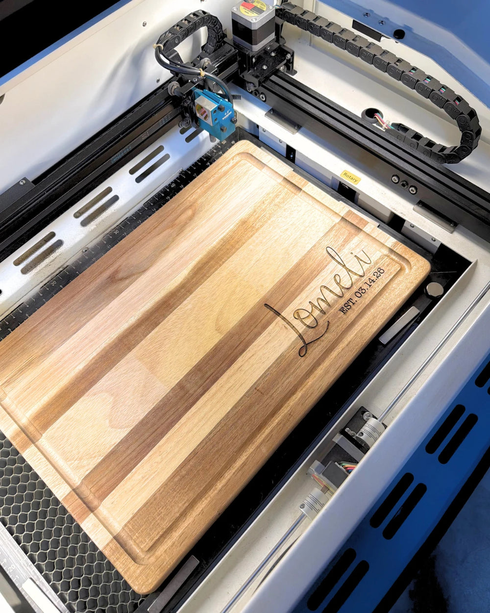 Personalized cutting board being engraved in the workshop