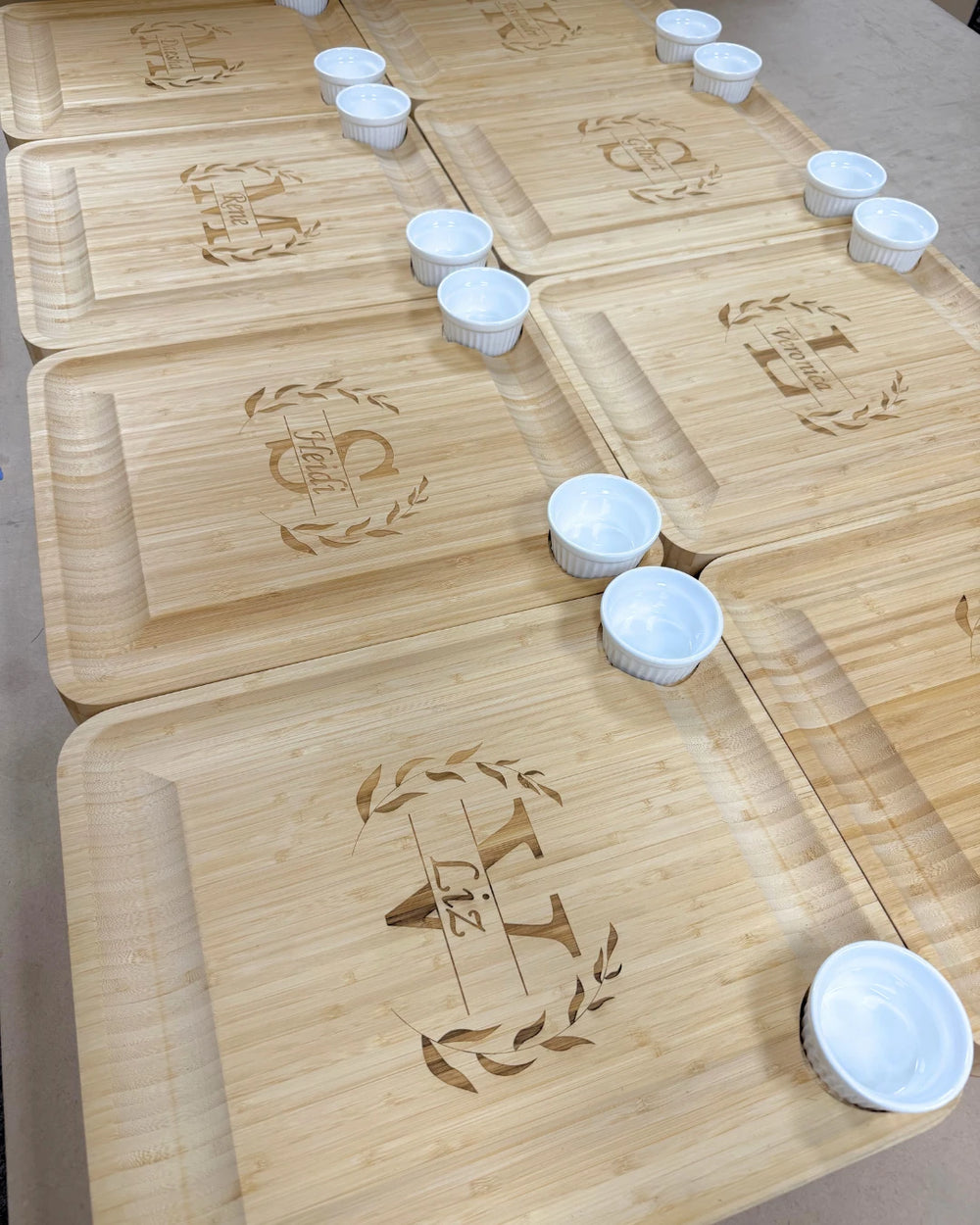 Batch of monogrammed bamboo serving boards