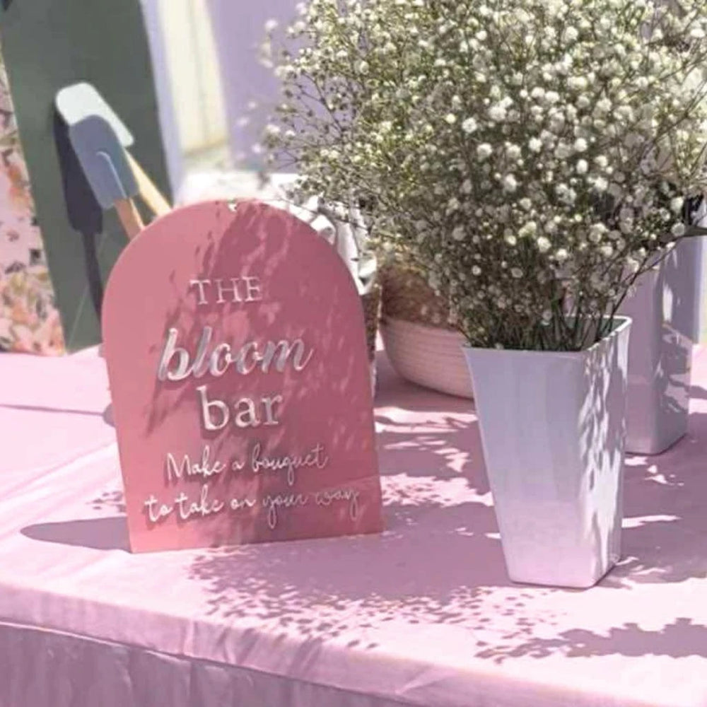 Pink floral bar sign at a bridal shower