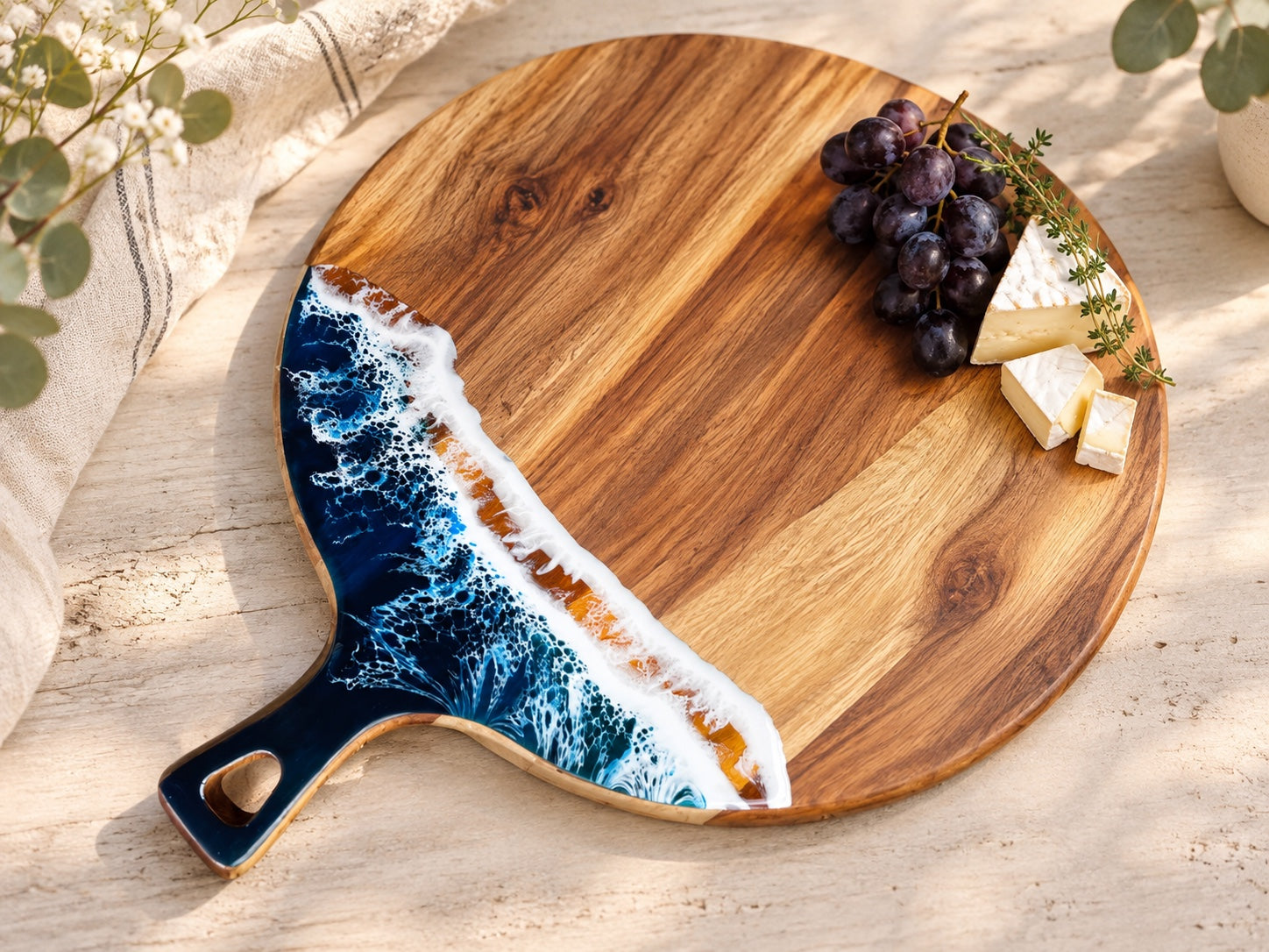 Round ocean resin serving board with grapes and cheese