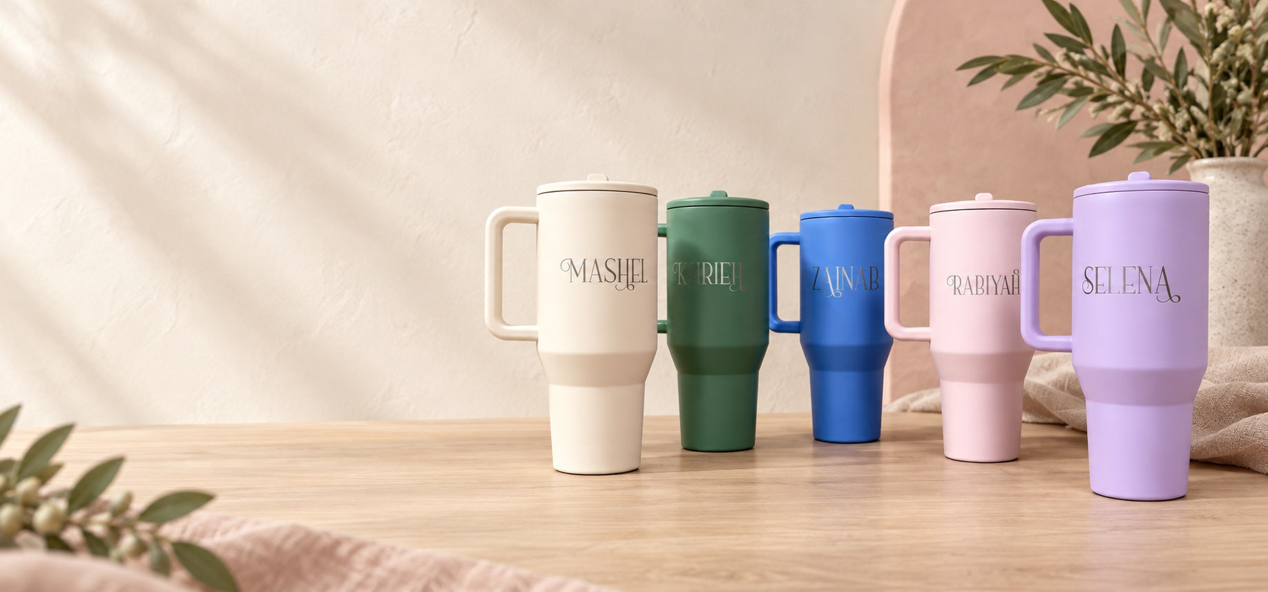 Five personalized handled tumblers in soft pastel colors