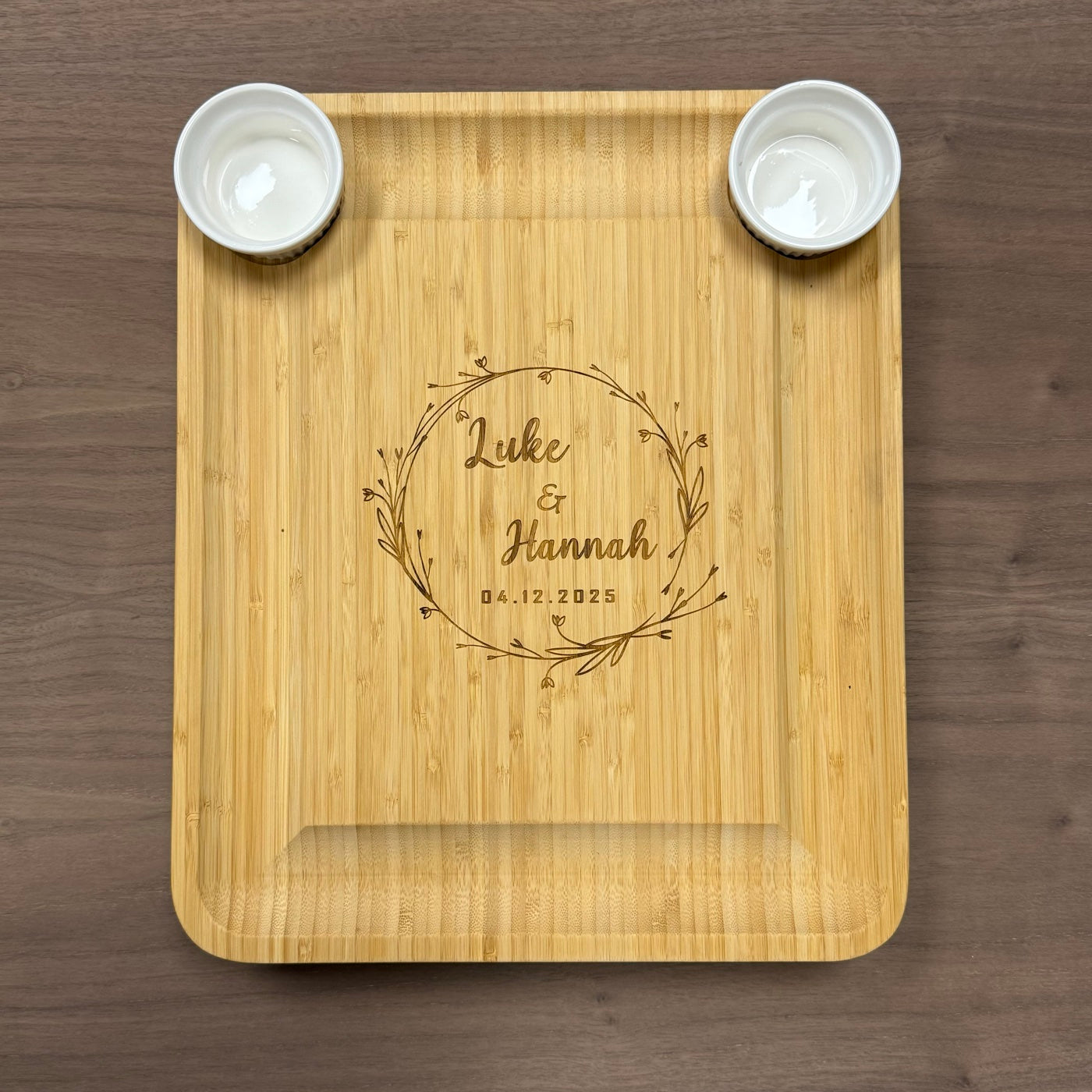 Wooden serving tray engraved with a couple’s names and wedding date